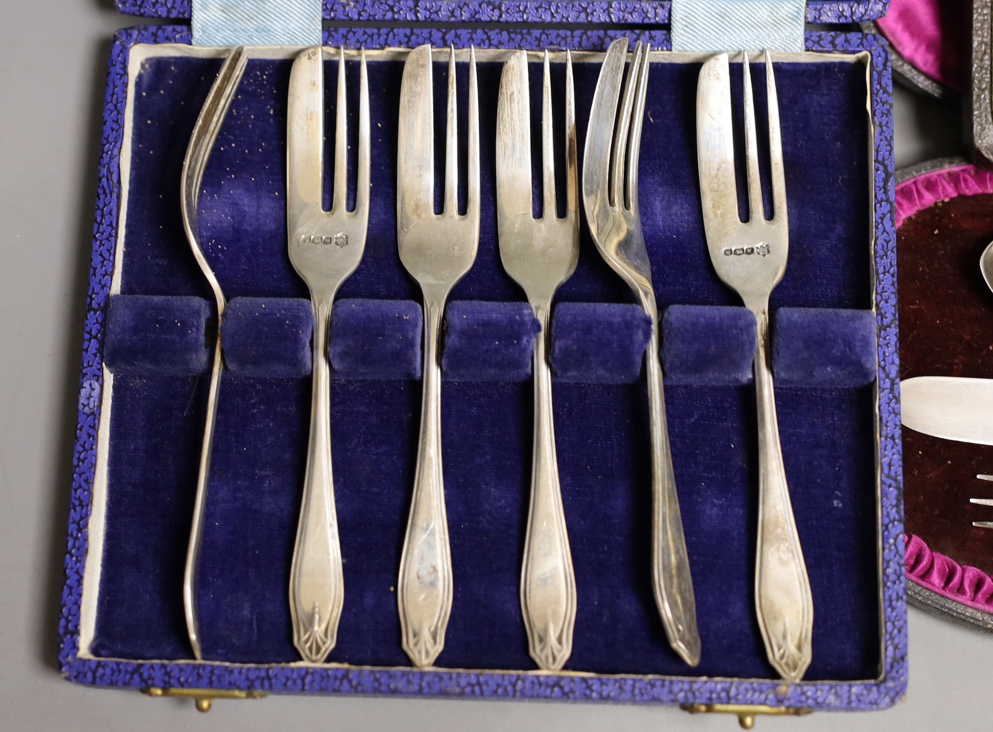 Four assorted cased sets of cutlery including a christening trio and a cased set of six silver and polychrome enamel, William Suckling Ltd. Birmingham, 1939.